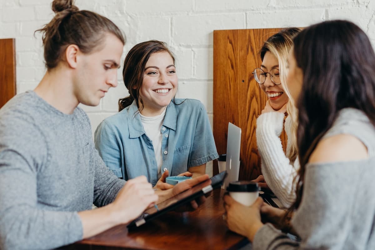 A group of friends laughing together at a café table
