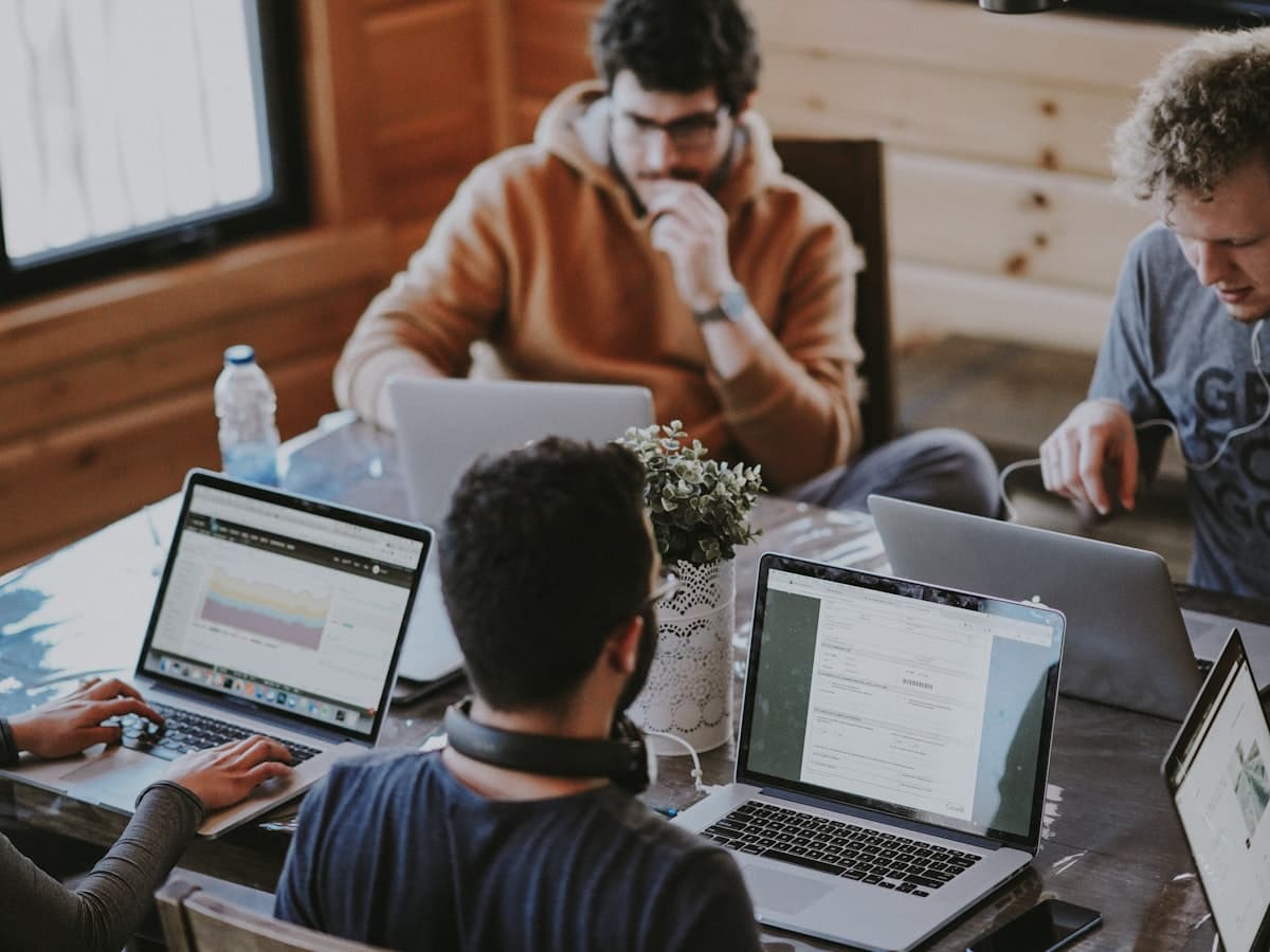 An open co-working floor with professionals at hot desks