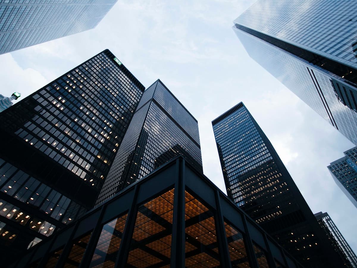 Looking up at modern glass office towers in a Delhi NCR business district